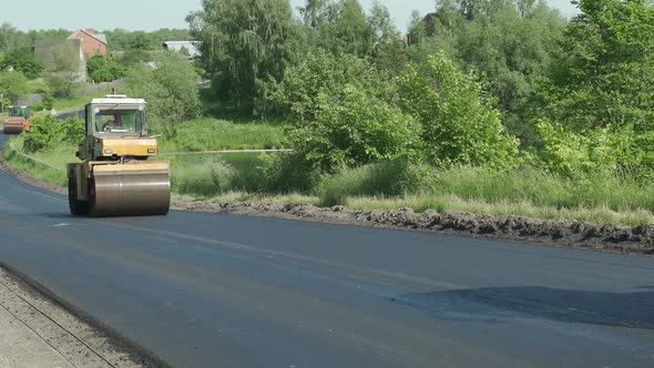 The Large Working Machine of the Skating Rink Makes a New Asphalt. Road Repair. Close-up