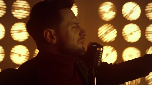 Fiery Showman Singing Song in Microphone Close Up