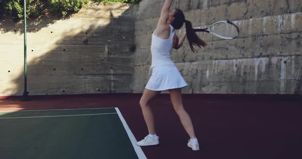 Woman playing tennis on a sunny day