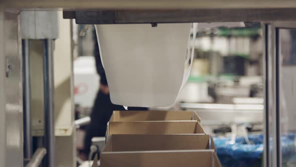 Red Wine bottles on a conveyor belt in a wine bottling factory.