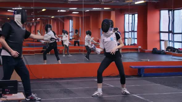 Fencing coach working with his student