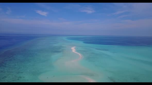 Aerial travel of perfect resort beach holiday by blue lagoon and white sandy background of a picnic 