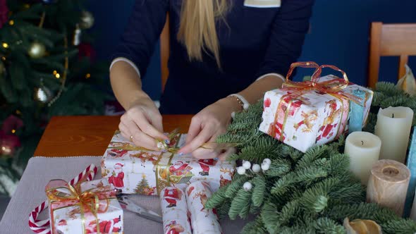 Female Hands Wrapping Christmas Presents