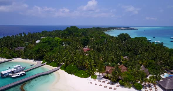 Tropical above island view of a sunshine white sandy paradise beach and aqua blue ocean background i