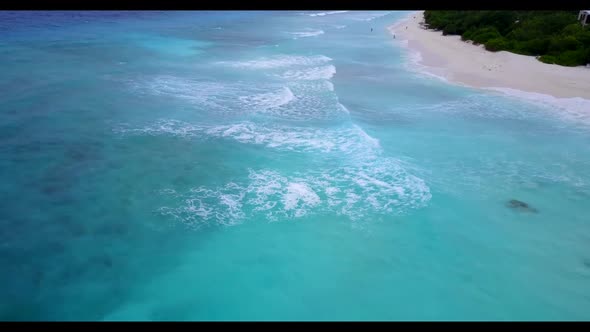 Aerial sky of relaxing seashore beach adventure by shallow water with white sand background of a day