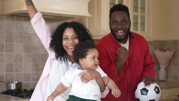 Happy Loving African American Family Posing in Kitchen at Home in Slow Motion