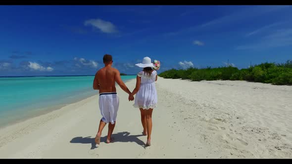 Young couple happy together on relaxing lagoon beach journey by blue green ocean and white sandy bac