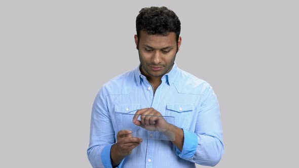 Portrait of Darkskinned Guy with Blank Glass Tablet