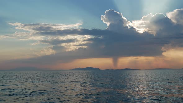 Sunset in Mesologgi Greece. Boat view of the sunset behind clouds and sea horizon.