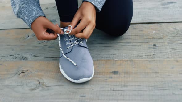 Woman tying her shoes lace