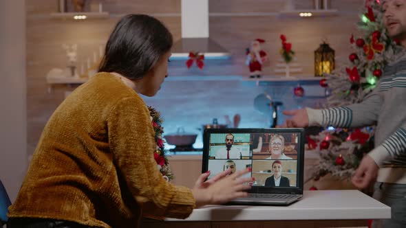 Woman Talking to Business People on Video Call Conference