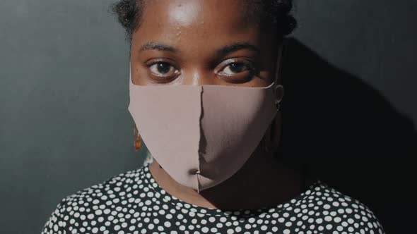 Portrait of Afro Woman in Face Mask in Studio