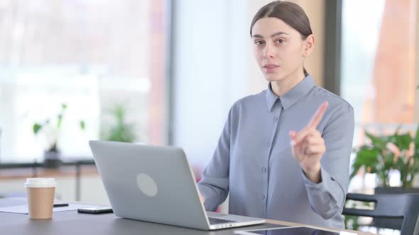No Gesture with Finger By Young Latin Woman at Work