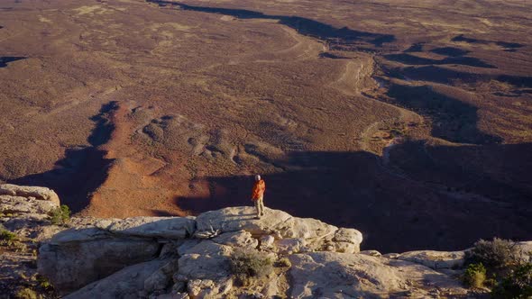 Aerial shot of a hiker at the the edge of Cedar Mesa in Utah