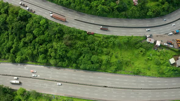 Flyby sideways over two parallel expressway roads as the traffic zooms past