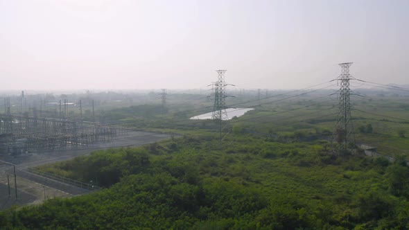 Aerial view of electricity generating, voltage poles. Power lines on utility tower and cable wires