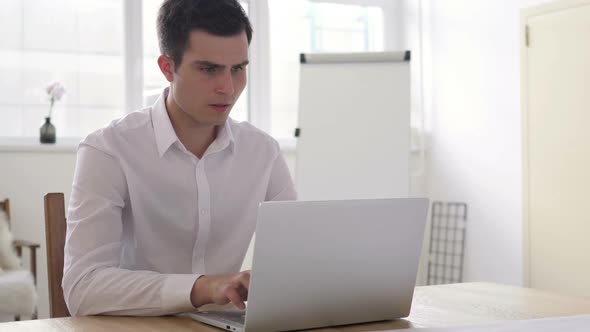 Upset Angry Businessman Yelling While Working on Laptop