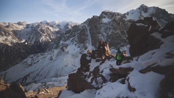 Man Running at the Mountain with Snow