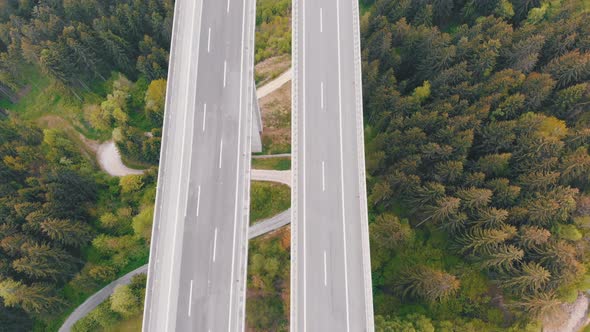 Aerial Top View of Highway Viaduct with Multilane Traffic in Mountains. Autobahn in Austria