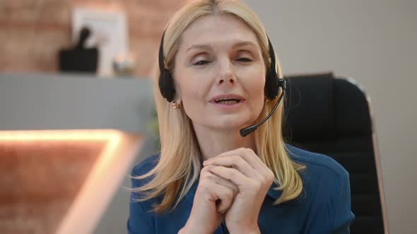 Closeup of a Friendly Successful Middle Aged Caucasian Businesswoman Female Call Center Operator