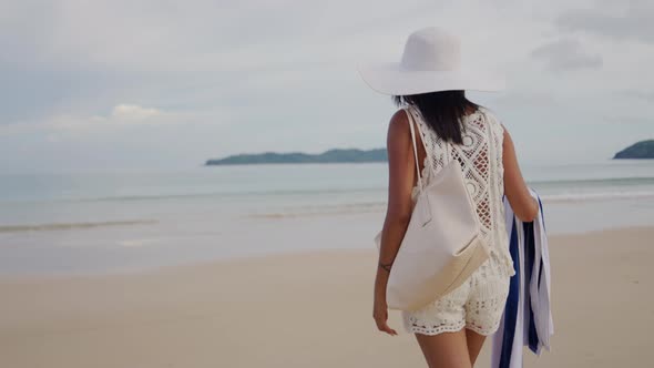 Woman In Sun Hat Walking On Nacpan Beach