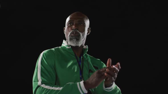 African american male coach clapping watching disabled male athlete with running blade training