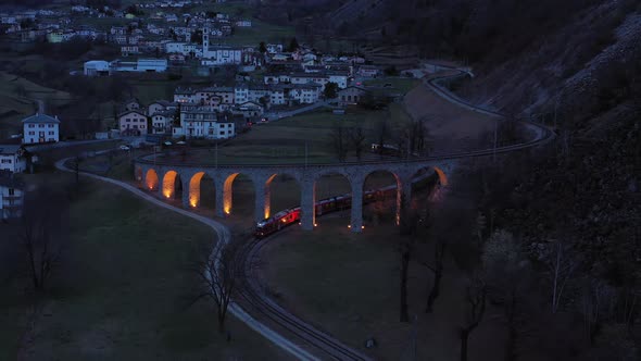 Train on Brusio Spiral Viaduct in Switzerland