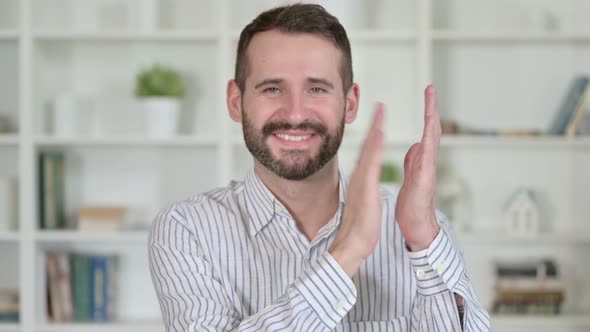 Portrait of Cheerful Young Man Clapping