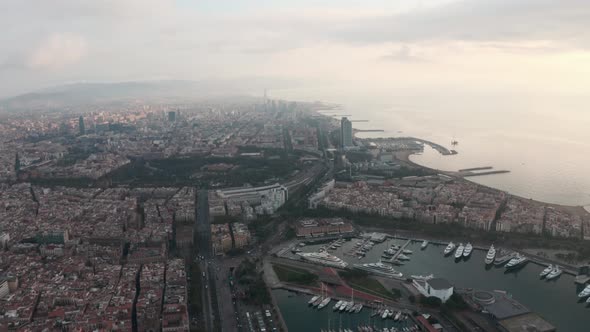 Circling drone shot over Barcelona port and Coast