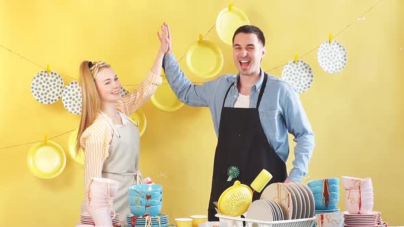 Positive Young Couple Rejoicing at Their Good Effective Dish Washing Liquid