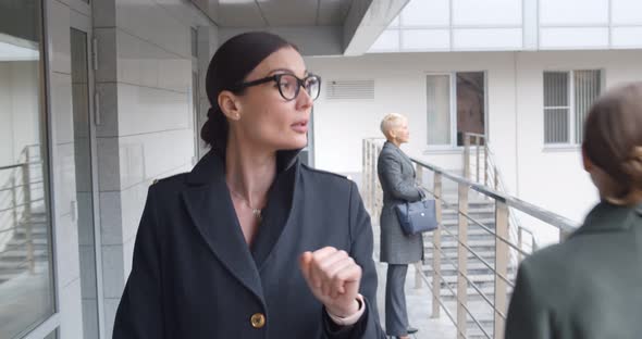 Confident Caucasian Woman in Business Wear Walking Near Urban Business Center