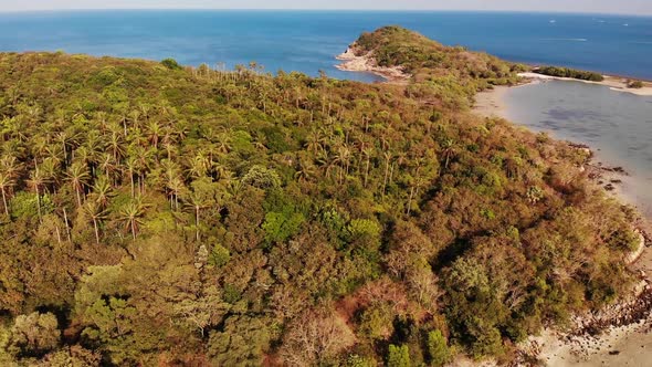 Small Island and Coral Reef in Ocean. Drone View of Green Uninhabited Island and Amazing Coral Reef