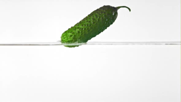Super Slow Motion Cucumber Falls Into the Water with Splashes