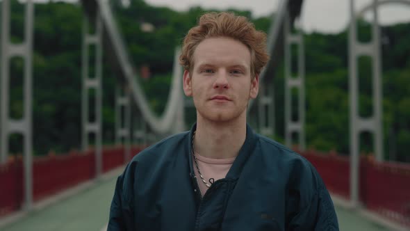 Portrait of Attractive Male Hipster with Red Curly Hair Using Personal Mobile Phone for Online