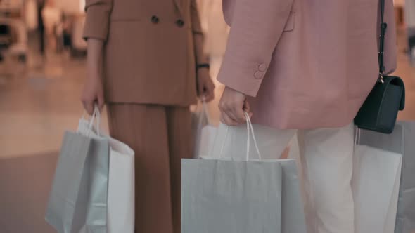 Unrecognizable Women Chatting after Shopping