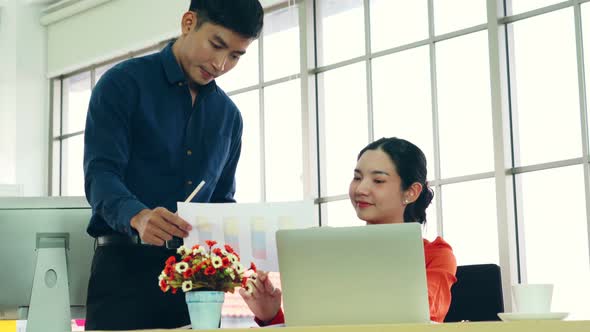 Two Business People Talk Project Strategy at Office