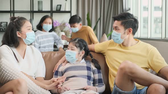 asian family multi generation wearing surgical facial mask together and stay home