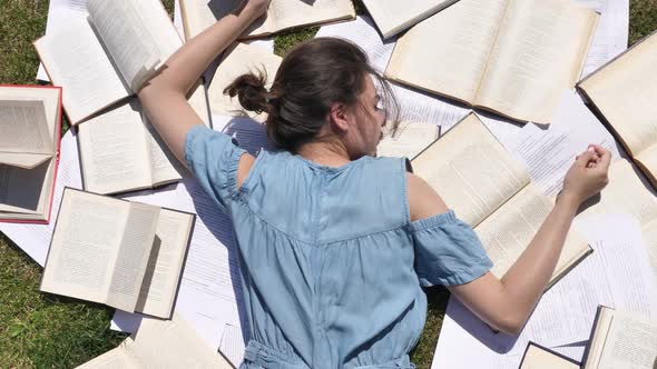 Young Female Fell Asleep on Books Outdoors Tired