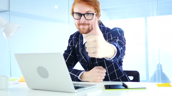 Thumbs Up by Creative Designer Working on Laptop