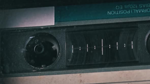 Audio Cassette Rotates in Deck of an Old Tape Recorder