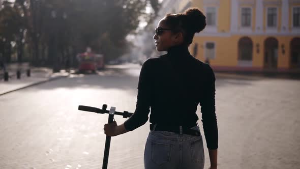 Rare View Footage of Mix Raced Woman Walking Along the City Street