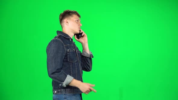 Handsome Guy Goes and Talks on the Phone, Chroma Key. Slow Motion. Side View