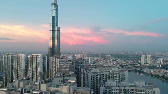 Beautiful aerial cityscape of Ho Chi Minh City reveal of Landmark 81 skyscraper and dusky sky, eveni