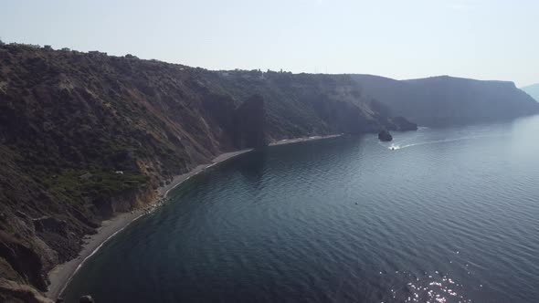 Aerial View From Above on Calm Azure Sea and Volcanic Rocky Shores