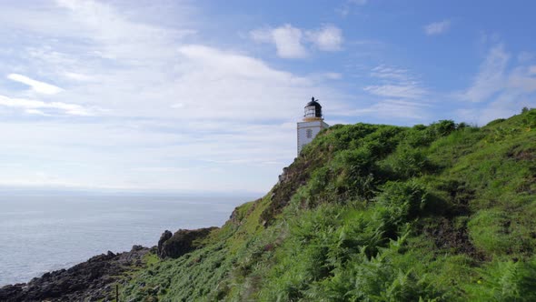 A Beautiful Square Lighthouse on a Cliff in the Summer