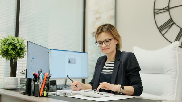 Woman Sit at Desk Using Computer Make Data Analysis Check Statistics Research Workday in Office