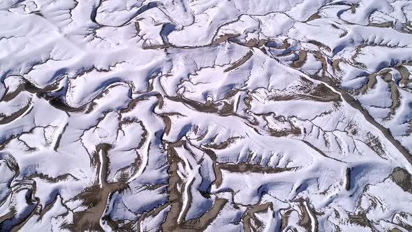 Aerial view of snow covering desert landscape viewing drainage system