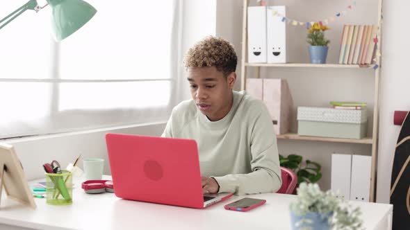 Disappointed Latin Teenager Boy Consulting Bad Exam Notes in School Campus Online