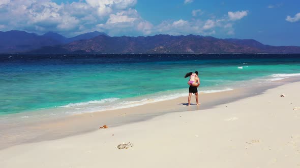 Young Man and Woman on Romantic Honeymoon Have Fun on Beach on Sunny White Sandy 