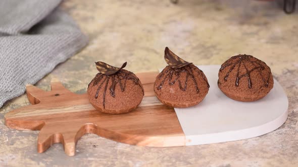 Decorating Choux Au Craquelin with Chocolate. Delicious French Dessert.